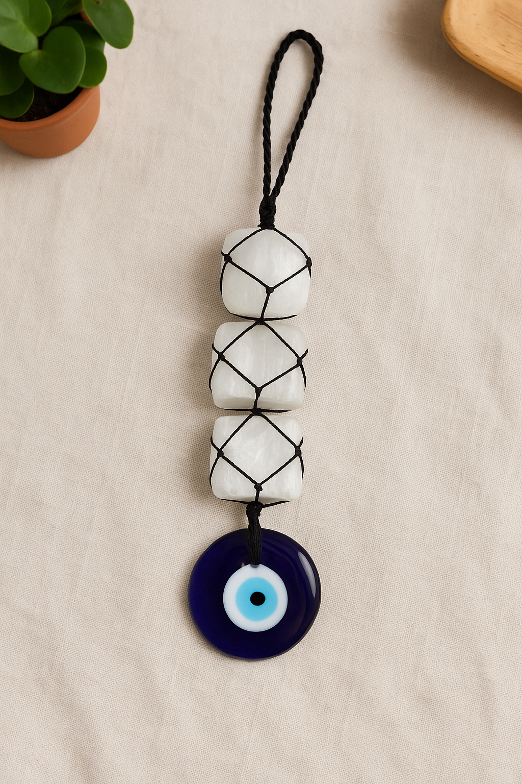 SELENITE WITH EVIL EYE HANGING